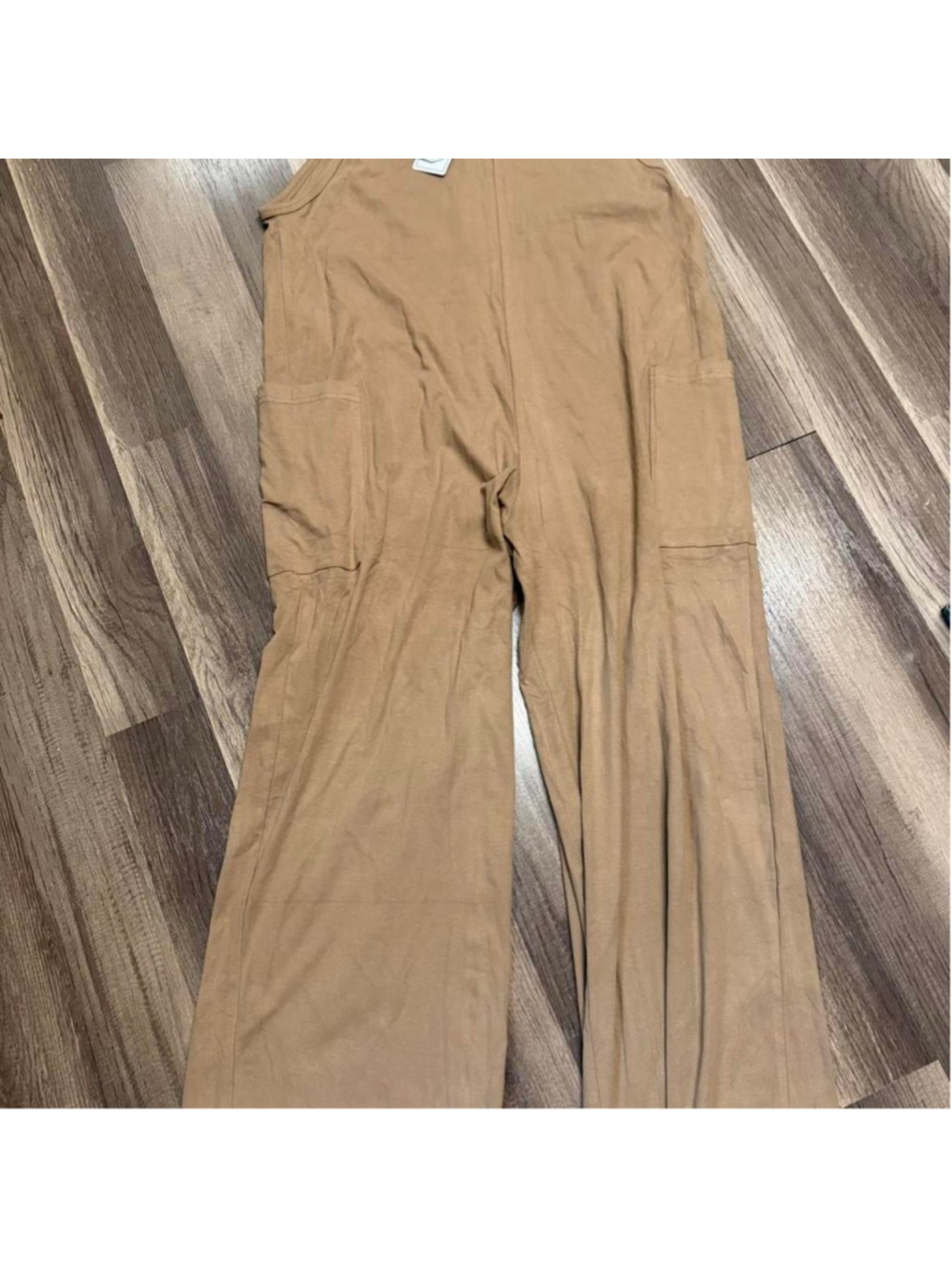 Utility cargo jumpsuit with a relaxed wide-leg silhouette, warm camel brown neut